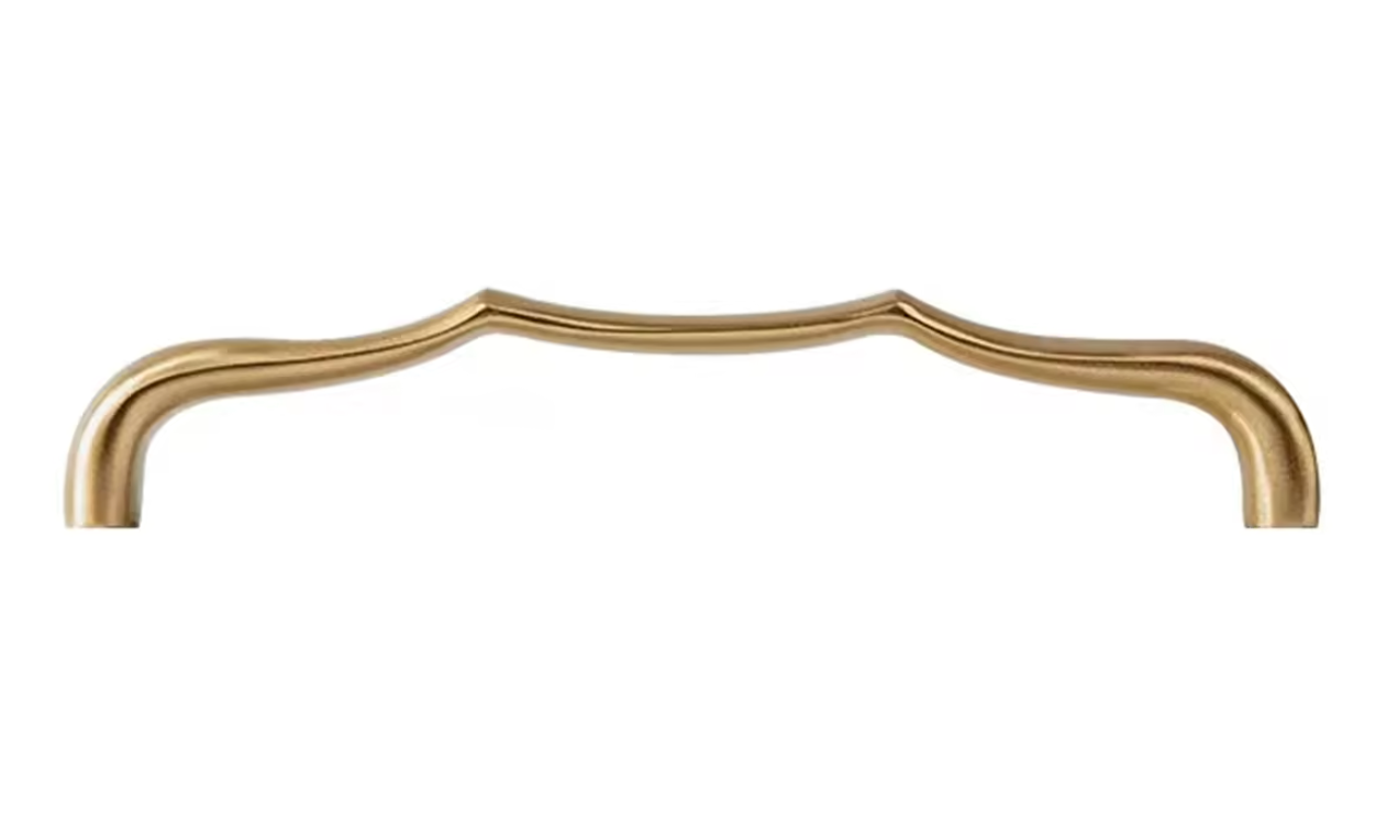 A single elongated cabinet pull handle with a curved, decorative top profile in a brushed brass or gold finish, shown against a plain white background.