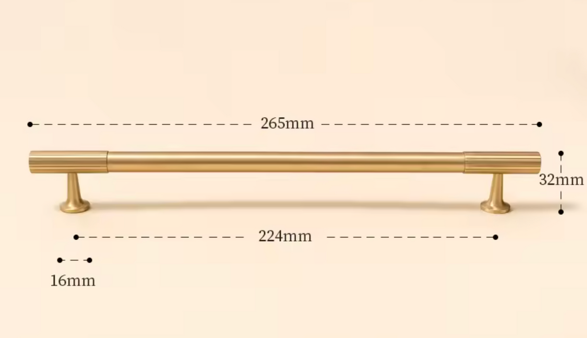 A brass cabinet pull handle with dimension markings showing a total length of 265mm, a width of 32mm, a post diameter of 16mm, and a center spacing of 224mm, set against a solid beige background.