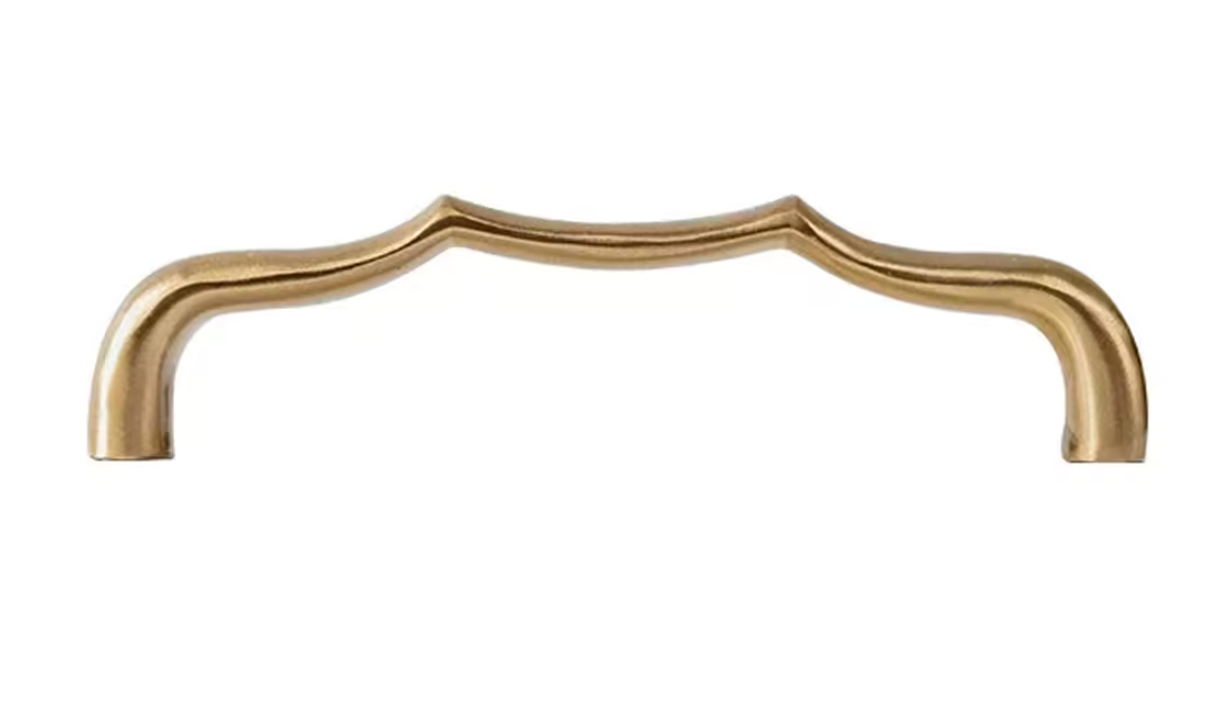 A single curved cabinet pull handle with a polished brass or gold finish, shown against a plain white background.