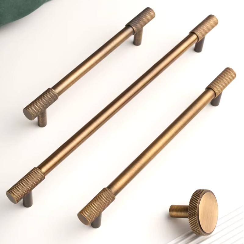 Three brass cabinet handles and one round knob shown on a clean white background.