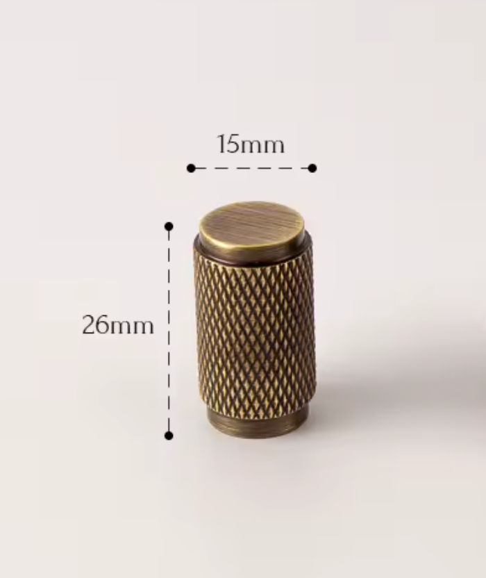 A small cylindrical metal knob with a textured knurled surface and a flat top, shown on a light neutral background with dimension labels reading 15mm across the top and 26mm tall on the side.