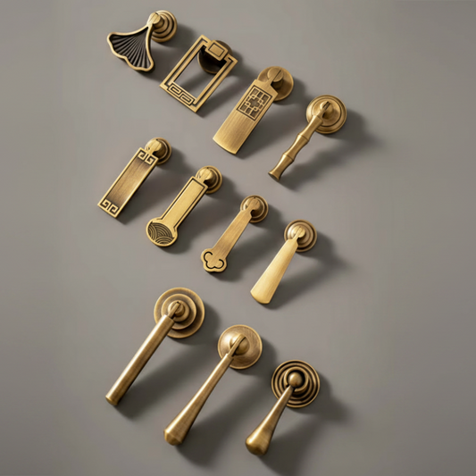 A set of antique brass door handles and pull knobs arranged on a neutral gray background, with a partial e-commerce sidebar visible on the right side of the image.