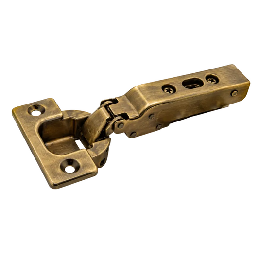 An antique brass hinge with a brushed finish, featuring a mounting plate on one side and a lever handle on the other, isolated on a white background.