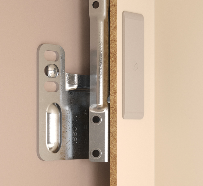 Close-up of a silver metal cabinet hinge attached to a beige door, with a matching beige door panel or trim visible beside it.